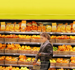 Woman buying fruits and vegetables at the market
