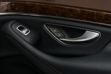 Obraz na płótnie Canvas Car door handle with windows control buttons.