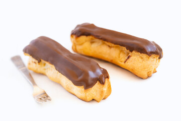 Traditional french dessert.Two eclairs  on white background. Sweet pastry products