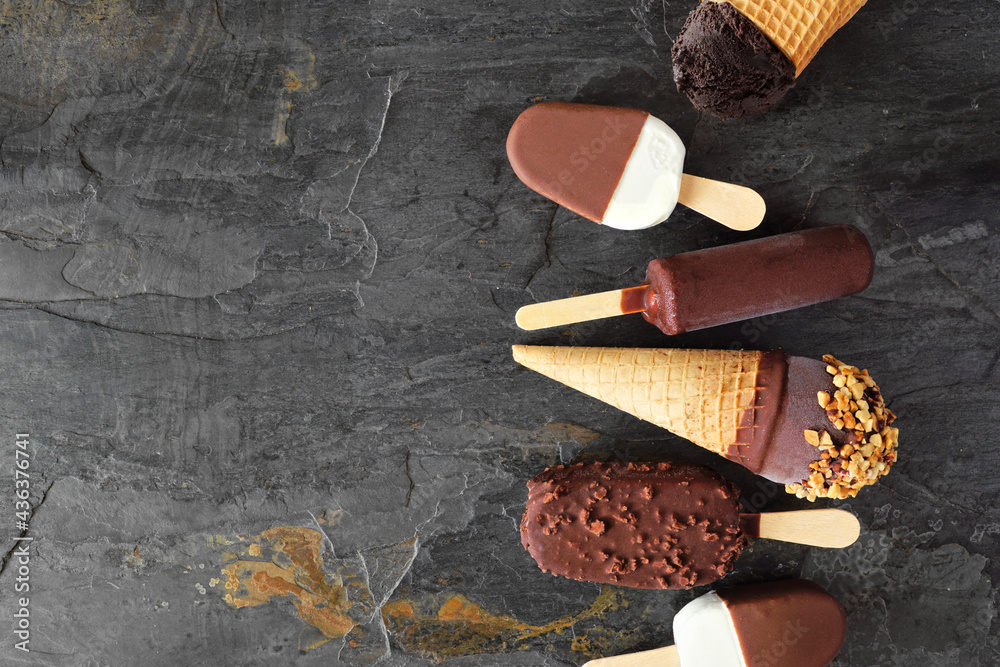 Poster Selection of chocolate ice cream desserts. Overhead view side border on a dark slate background with copy space.