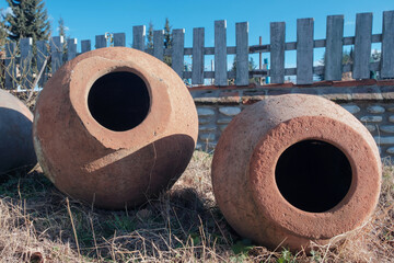 Georgian traditional ancient jug for wine qvevri on the ground, selective focus