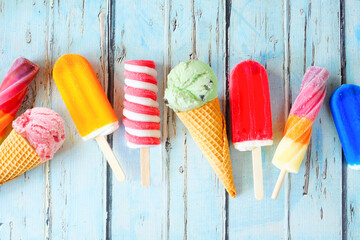 Selection of colorful summer popsicles and ice cream treats. Overhead view scattered on a rustic...