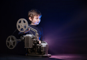 Little boy watching a movie on an old retro projector