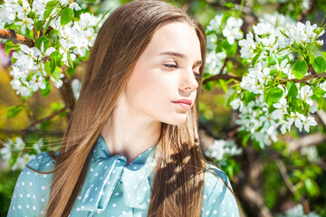 Close up ortrait of a young beautiful woman in a turquoise dress