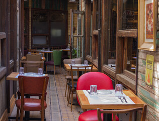 Outdoor restaurant with empty tables.