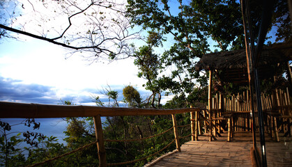 bamboo hut on top of a mountain overlooking sea