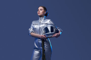 Young spacewoman in silver suit holding helmet © Fxquadro