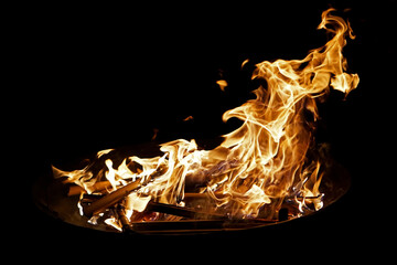 Bonfire with fantastic blazing flames and black background in the night