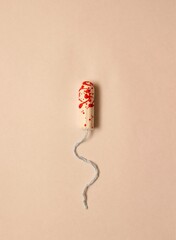 white tampon with blue thread