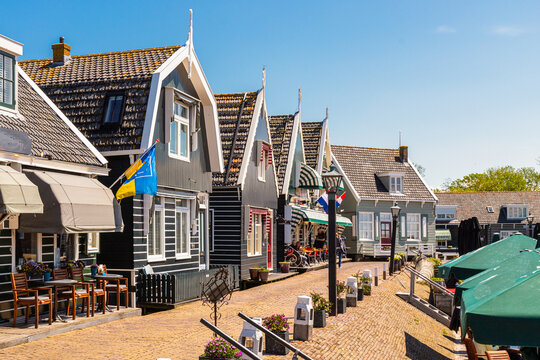 Catering establishments and souvenir shops in traditional wooden houses at the small harbor in the picturesque fishing village of Marken.