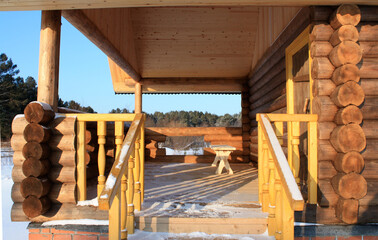Wooden porch of a newly built house in winter.