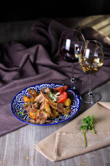 onions and tomatoes on a blue plate with wine