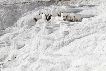 Fototapeta na wymiar white magic in Pamukkale - limestone travertine formations pools with mineral water from hot springs