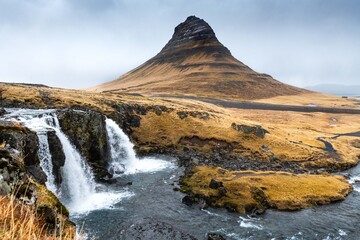 Kirkjufellsfoss waterfall and Kirkjufell  mountain on the north coast of Iceland's Snæfellsnes peninsula, near the town of Grundarfjörður.