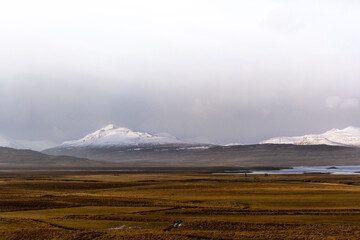 Iceland's off-road, Snow-capped mountains against the backdrop of meadows - 436388164