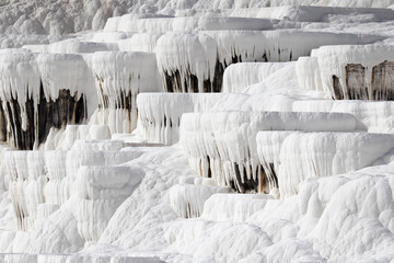 Close up of white limestone natural travertine terraces in pamukkale with pools full of carbonated water