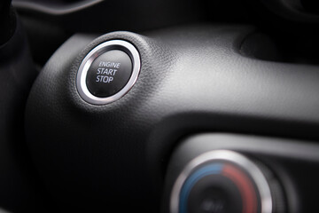 Closeup detail of a ignition button start-stop in the car.Start stop engine modern new car button.