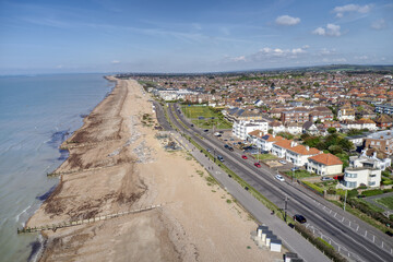 Fototapeta na wymiar West Worthing seafront promenade and West Parade road heading along the beach towards Goring by Sea. Aerial view.