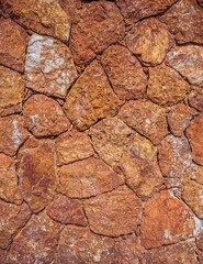 rough irregular cut brown stone wall, seamless pattern textured background