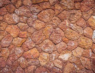 rough irregular cut brown stone wall, seamless pattern textured background