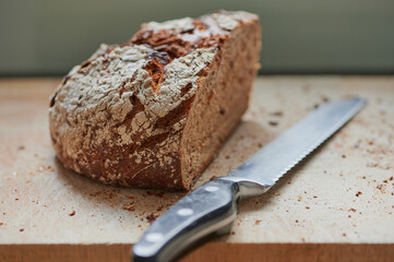 half loaf of rye bread beside a knife