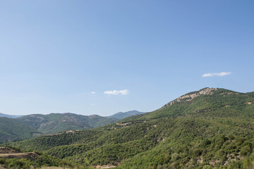 Fototapeta na wymiar Beautiful Greek mountains and green hills with blue sky. Travel destination, nature landscape