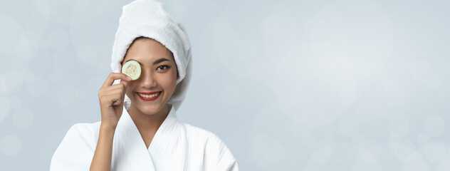 Natural homemade fresh cucumber facial eye pads facial masks. Asian woman holding cucumber pads and smile relax with natural homemade.