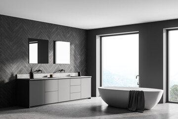 Fototapeta na wymiar Spacious modern bathroom design interior in gray tones with concrete floor, freestanding tub, double sink vanity. Panoramic window.