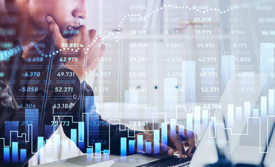 African American businessman or stock trader analyzing stock graph chart using laptop to buy or sell shares, side view portrait. Internet trading concept.