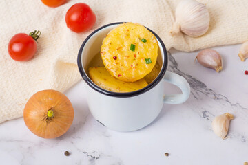 onion soup in a mug on a light background