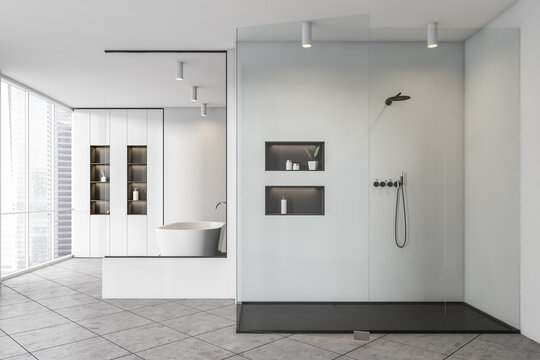 Bathroom interior with shower, bathtub with shelf near window