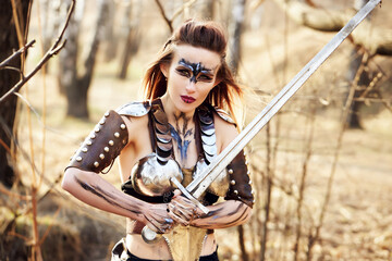 Fototapeta na wymiar Beautiful amazon woman posing with sword