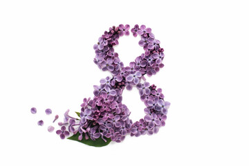the number 8 is carved in white paper and filled with purple spring lilac flowers. greeting card with the international women's day on March 8