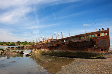 The rusted hulk of the former Gosport ferry "Vadne" (built 1939 and in service until 1965), abandoned in Forton Lake, an arm of Portsmouth Harbour, Gosport, Hampshire, UK