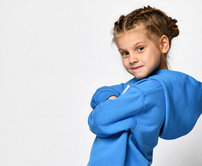 Close up portrait of a cool little girl in a blue hoodie on a white background. Stylish child...