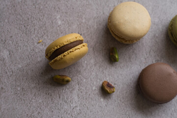 Colorful macarons and pistachios isolated. French meringue cookie macaron.