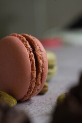 Colorful macarons and pistachios isolated. French meringue cookie macaron.