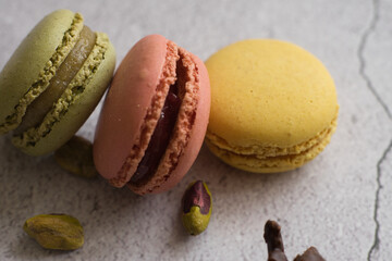 Colorful macarons and pistachios isolated. French meringue cookie macaron.