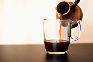 glass cup with coffee on a black table