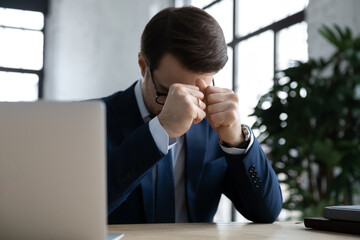 Tired overworked business professional going through stress at workplace, feeling fatigue, burnout,...