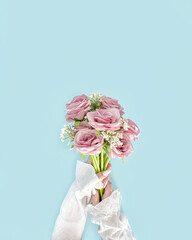 Wedding bouquet of fresh pink flowers .in the hands of bride. Ready to throw a bouquet. Creative concept of .roses on pastel blue background. Flat lay.