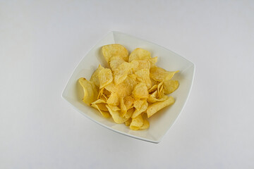 Potato chip crisps in a white bowl