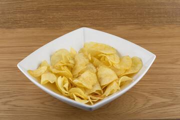 Potato chip crisps in a white bowl