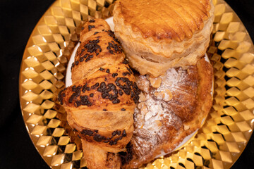 Chocolate, almond, and apple turnover on gold plate