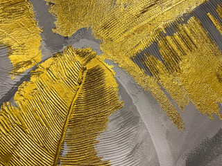 Beautiful gold and black festive expensive surface texture painted with gold paint and gold leaf. The background