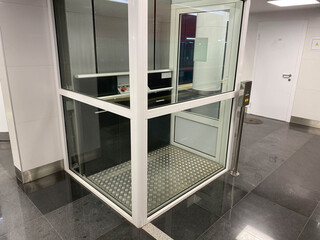 Large new inclusive elevator in the metro or shopping center for people with disabilities and...