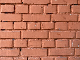 Red bricks old surfaces shabby with seams painted with red paint. The background. Texture