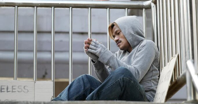 Homeless man sitting on the overpass