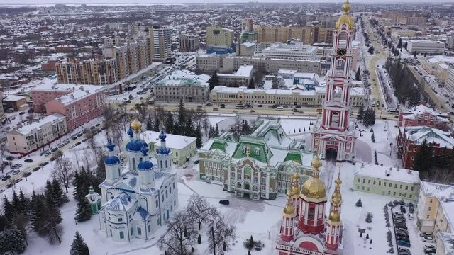 Scenic aerial view of snow covered cityscape of Russian city of Tambov overlooking colorful architectural complex of Monastery of Our Lady of Kazan on winter day. High quality 4k footage