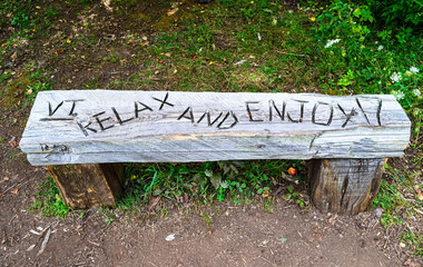 A solid wood bench with the message 